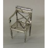 An unusual silver table toy in the form of a chair