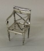 An unusual silver table toy in the form of a chair