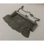 A heavy silver mesh purse on suspension chain. App