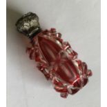 A hinged top silver mounted cranberry glass scent