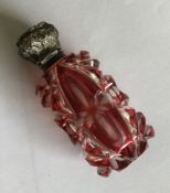 A hinged top silver mounted cranberry glass scent