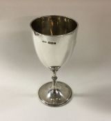 A silver goblet with beaded border on pedestal foo