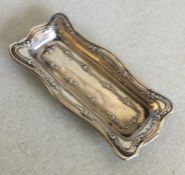 A small silver shaped edged pin dish. Birmingham.