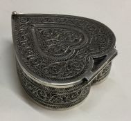 A silver filigree hinged top box with scroll decor