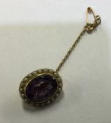 An amethyst and pearl brooch in claw mount. Approx