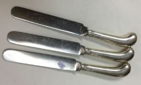 A set of three silver handled knives with steel bl