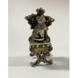 A miniature cast silver chair with a seated cat. B