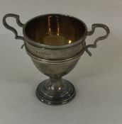 A small silver two handled trophy cup. Est. £25 -