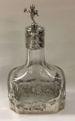 A chased silver mounted scent bottle decorated wit