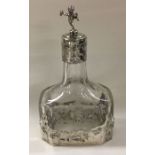 A chased silver mounted scent bottle decorated wit
