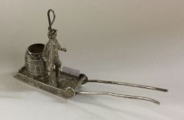 A novelty silver table toy in the form of a man an