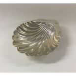 An Edwardian silver scallop shaped butter shell on