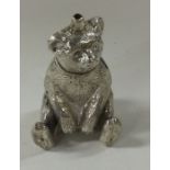 A heavy silver figure of a bear with textured body