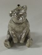 A heavy silver figure of a bear with textured body