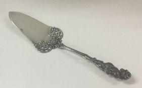 A Continental silver pierced cake slice with flora