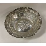 A large silver bonbon dish decorated with flowers
