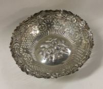 A large silver bonbon dish decorated with flowers