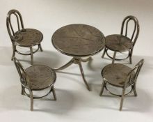 A set of four miniature Chinese silver chairs and