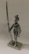 A silver figure of a knight. Approx. 51