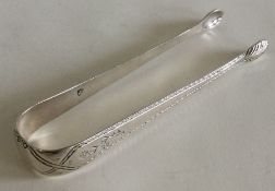 A good pair of Georgian bright cut silver sugar to