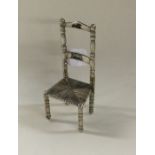A small Chinese silver chair. Approx. 10 grams. Es