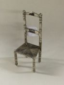 A small Chinese silver chair. Approx. 10 grams. Es