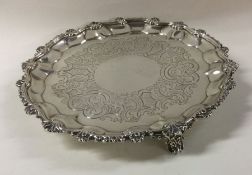 A George III silver waiter with shell border. Lond