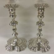 A fine pair of George II cast silver candlesticks