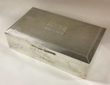 A heavy engine turned silver cigarette box. Approx