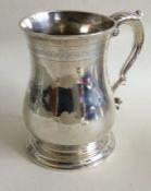 A heavy George III baluster shaped mug with scroll