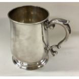 A George II silver mug decorated with armorial.