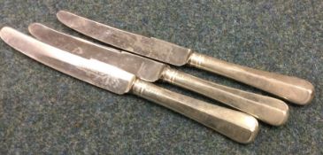 A set of three silver handled knives with steel bl