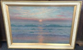 A large framed and glazed sunset picture.