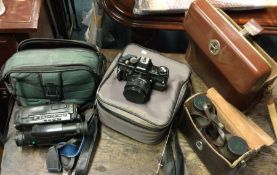 A collection of old cameras and binoculars.