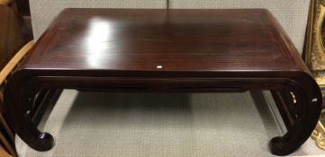 An old hardwood opium table of Oriental design.