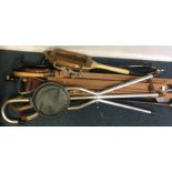 A collection of old walking sticks and shooting st