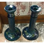 A pair of blue Forget-me-not patterned, Florentine ware, Moorcroft candlesticks.