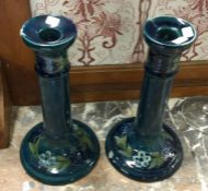 A pair of blue Forget-me-not patterned, Florentine ware, Moorcroft candlesticks.