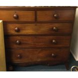 A large mahogany chest of five drawers.