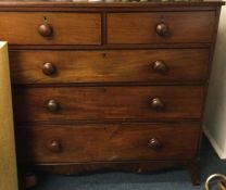 A large mahogany chest of five drawers.