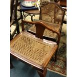 Two cane seated chairs.
