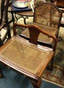 Two cane seated chairs.