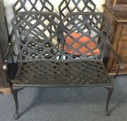 A cast aluminium three piece patio set.