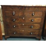A massive flame mahogany chest of five drawers to