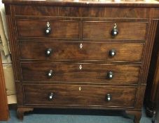 A massive flame mahogany chest of five drawers to