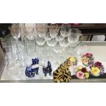 A collection of wine glasses, pottery cats etc.