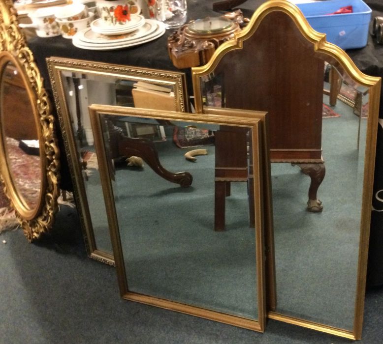 Three gilt framed mirrors.