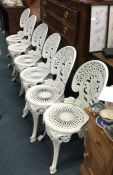 A set of six cast aluminium garden chairs.