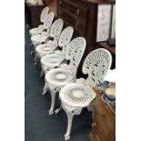 A set of six cast aluminium garden chairs.