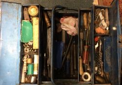 A large tin containing various tools.